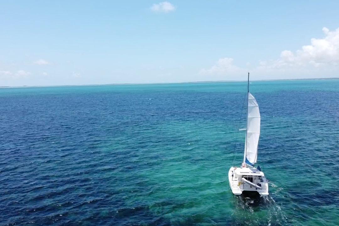 Sailing catamaran Leopard 38, 2010 model, cruising on clear blue ocean waters.
