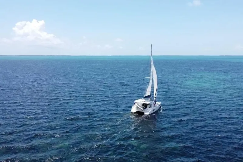 Way Maker Yacht Photos Pics Sailing catamaran Leopard 38 on open ocean, clear blue skies, 2010 model.