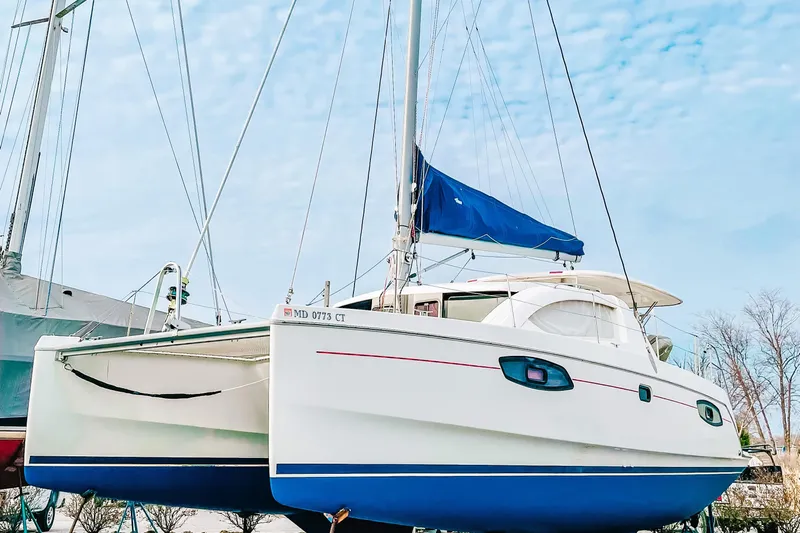 Way Maker Yacht Photos Pics 2010 Leopard 38 catamaran with blue sail cover, docked under clear sky.