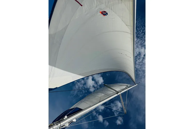 Way Maker Yacht Photos Pics Sailing yacht Leopard 38, 2010 model, with sails against a blue sky.