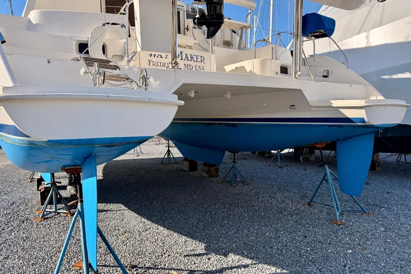 Way Maker Yacht Photos Pics Leopard 38 catamaran from 2010 on stands, displayed outdoors on gravel.