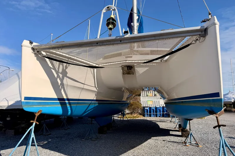 Way Maker Yacht Photos Pics 2010 Leopard 38 catamaran on stands, blue and white hull, sunny day.