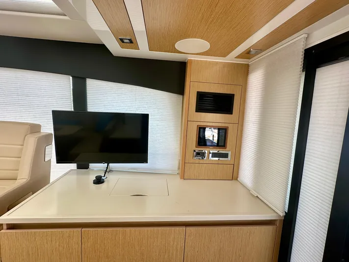 Nan Sea Cay Yacht Photos Pics Modern interior of 2020 Sealine C430 yacht with TV and wooden cabinetry.