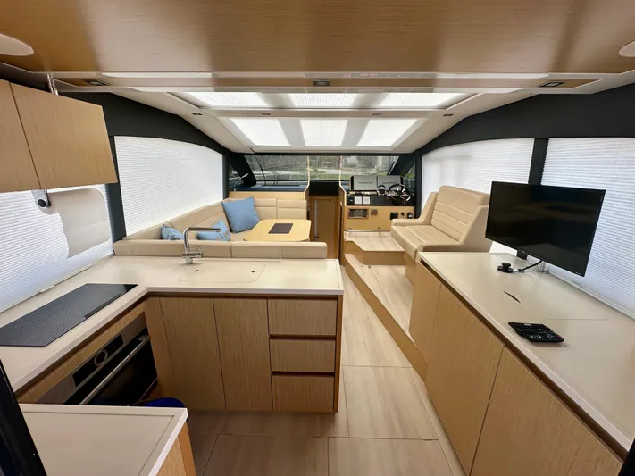 Nan Sea Cay Yacht Photos Pics Interior of 2020 Sealine C430 yacht with modern kitchen, seating, and entertainment area.