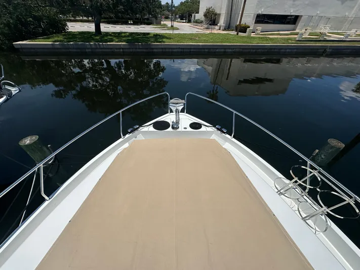 Nan Sea Cay Yacht Photos Pics Bow view of 2020 Sealine C430 yacht docked by a calm waterfront.
