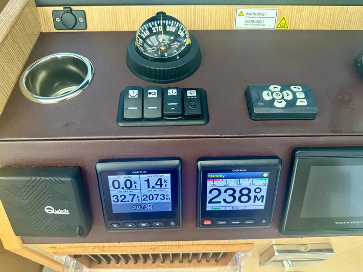 Nan Sea Cay Yacht Photos Pics Control panel of a 2020 Sealine C430 yacht with navigation instruments and compass.