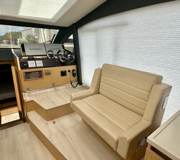 Nan Sea Cay Yacht Photos Pics Interior of 2020 Sealine C430 yacht with beige seating and navigation equipment.