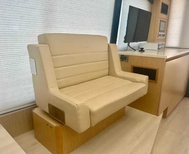 Nan Sea Cay Yacht Photos Pics Beige seating in 2020 Sealine C430 yacht interior, featuring modern design and wood accents.