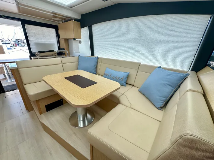 Nan Sea Cay Yacht Photos Pics Luxurious interior of 2020 Sealine C430 yacht with beige seating and wooden table.