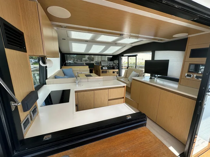 Nan Sea Cay Yacht Photos Pics Luxurious interior of 2020 Sealine C430 yacht with modern kitchen and seating area.