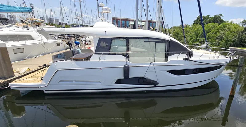 Nan Sea Cay Yacht Photos Pics 2020 Sealine C430 yacht docked at marina, sleek design, white exterior, calm water reflection.