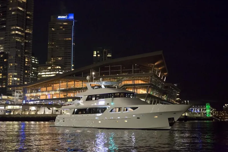 Encore Yacht Photos Pics Luxurious 1992 Crescent Custom yacht docked at night near illuminated cityscape.