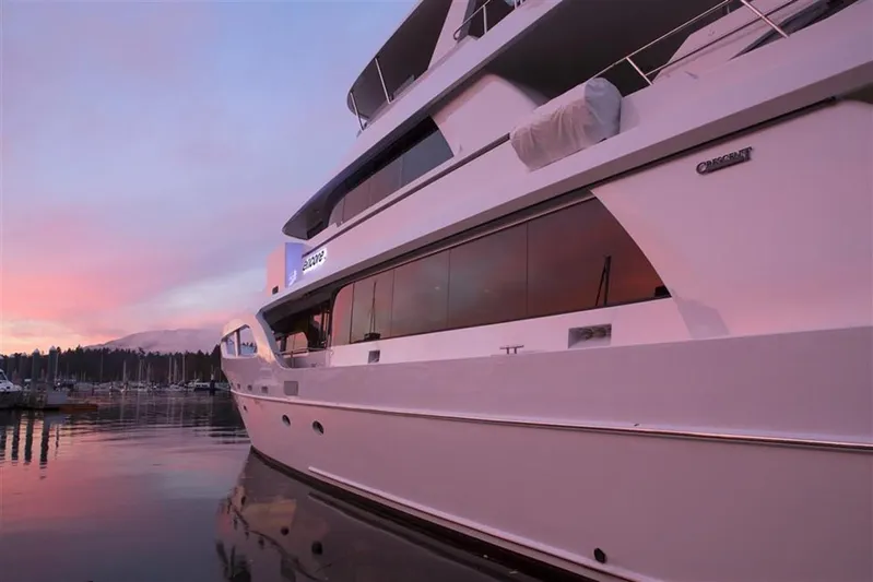 Encore Yacht Photos Pics Luxury Crescent Custom yacht from 1992 at sunset, docked in a serene marina.