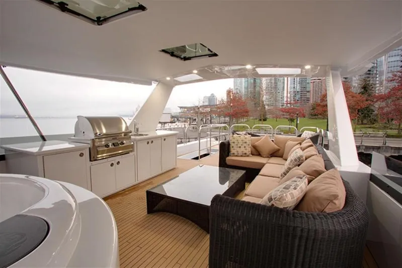 Encore Yacht Photos Pics Luxurious 1992 Crescent Custom yacht deck with seating, grill, and cityscape view.