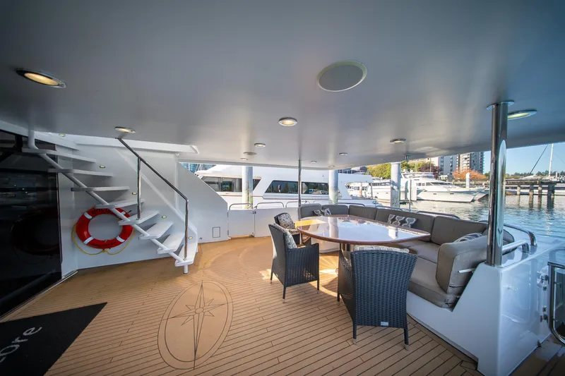 Encore Yacht Photos Pics Luxurious 1992 Crescent Custom yacht deck with seating, table, and marina view.