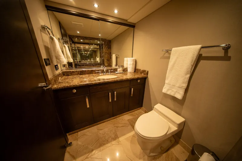 Encore Yacht Photos Pics Luxurious bathroom with marble countertop, elegant fixtures, and soft lighting in a 1992 Crescent Custom.