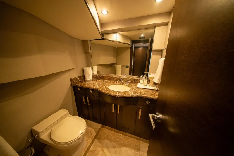 Encore Yacht Photos Pics Luxurious bathroom in 1992 Crescent Custom yacht with marble countertop and modern fixtures.