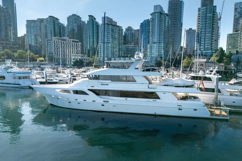Encore Yacht Photos Pics Luxurious 1992 Crescent Custom yacht docked in a marina with city skyline backdrop.