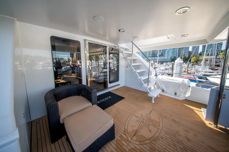 Encore Yacht Photos Pics Luxurious 1992 Crescent Custom yacht deck with seating, stairs, and marina view.