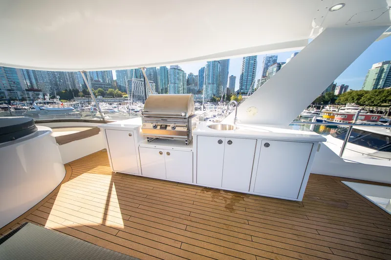 Encore Yacht Photos Pics Luxurious 1992 Crescent Custom yacht deck with outdoor kitchen and city skyline view.