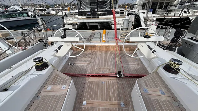 Zenith Yacht Photos Pics Italia Yachts 14.98, 2023 model, featuring dual steering wheels and teak deck at a marina.