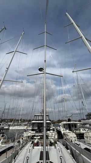 Zenith Yacht Photos Pics Italia Yachts 14.98 sailboat, 2023 model, docked with tall masts under cloudy sky.
