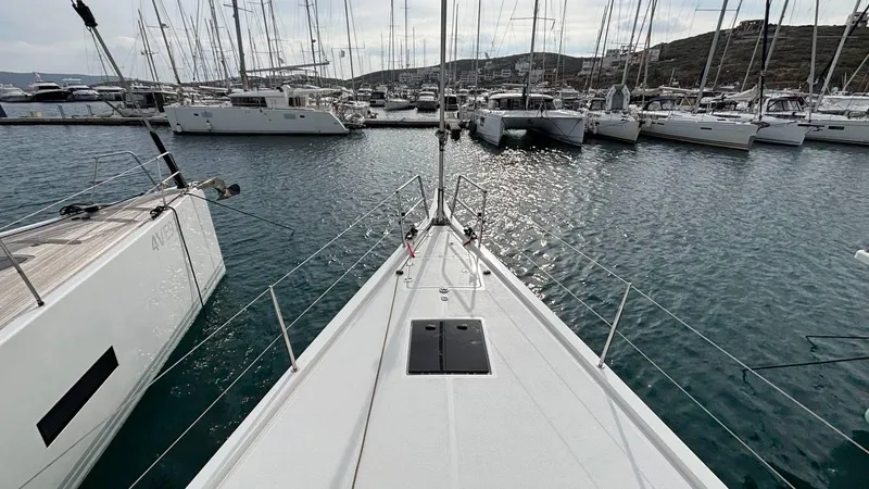 Zenith Yacht Photos Pics Italia Yachts 14.98 (2023) docked in a marina with surrounding sailboats.