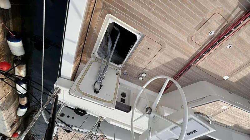 Zenith Yacht Photos Pics Italia Yachts 14.98, 2023 model, deck view with steering wheel and open hatch.