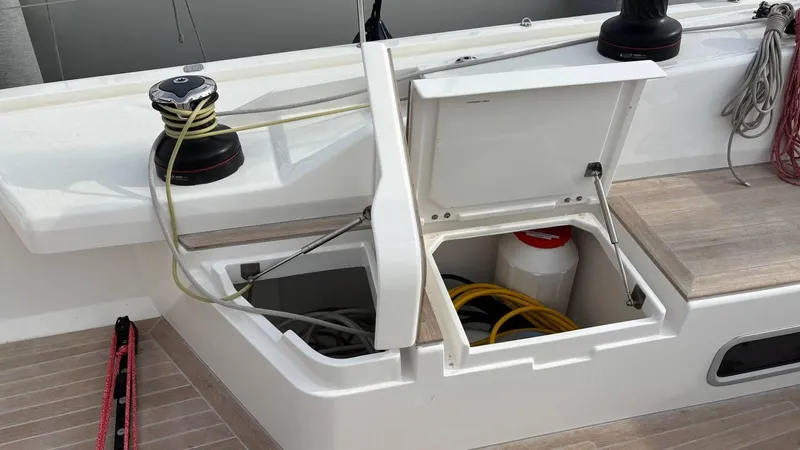 Zenith Yacht Photos Pics Italia Yachts 14.98 sailboat deck with open storage compartments, winches, and ropes, 2023 model.