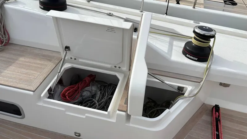 Zenith Yacht Photos Pics Italia Yachts 14.98 sailboat deck with open storage compartment, ropes, and winch, 2023 model.