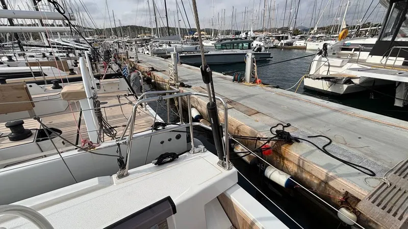 Zenith Yacht Photos Pics Italia Yachts 14.98 (2023) docked at marina, surrounded by other sailboats.