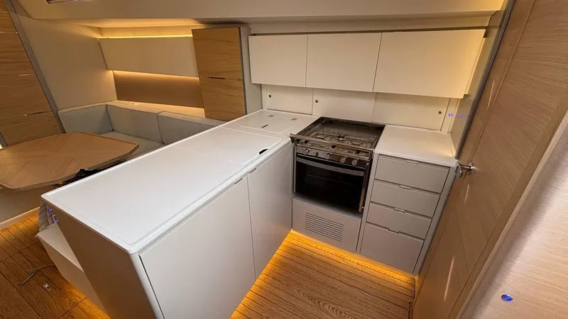 Zenith Yacht Photos Pics Modern interior of 2023 Italia Yachts 14.98, featuring sleek kitchen design and ambient lighting.