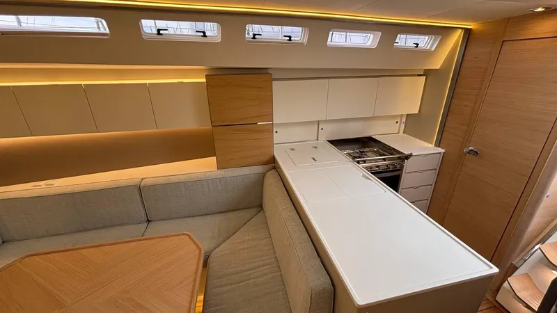 Zenith Yacht Photos Pics Luxurious interior of 2023 Italia Yachts 14.98, featuring modern kitchen and seating area.
