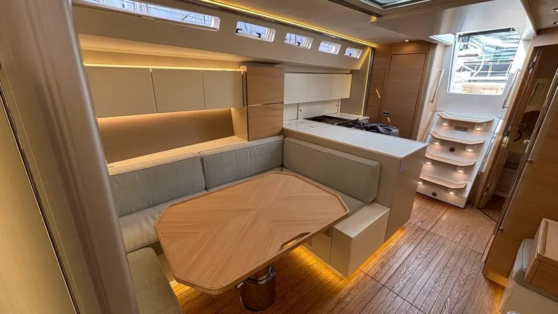 Zenith Yacht Photos Pics Luxurious interior of 2023 Italia Yachts 14.98, featuring modern seating and elegant wood finishes.