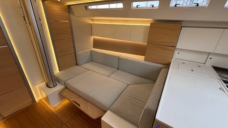 Zenith Yacht Photos Pics Luxurious interior of 2023 Italia Yachts 14.98, featuring modern seating and elegant wood finishes.
