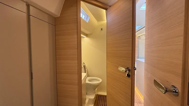 Zenith Yacht Photos Pics Italia Yachts 14.98 2023 interior bathroom with wooden doors and modern fixtures.