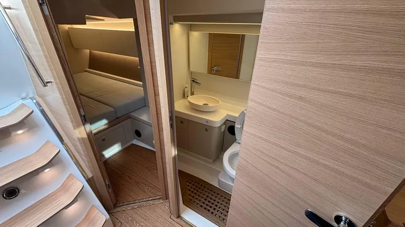 Zenith Yacht Photos Pics Luxurious interior of 2023 Italia Yachts 14.98, featuring a modern bathroom and cozy cabin.