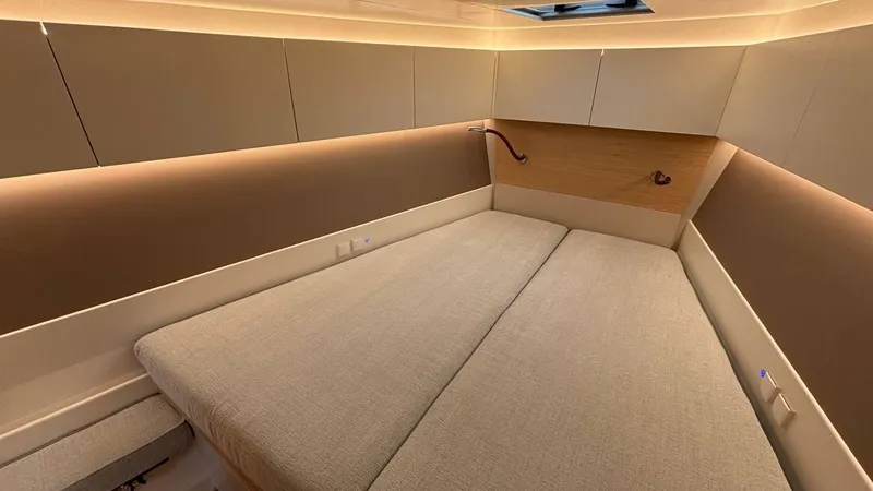 Zenith Yacht Photos Pics Luxurious cabin interior of 2023 Italia Yachts 14.98 with modern lighting and cozy bedding.