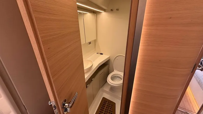 Zenith Yacht Photos Pics Italia Yachts 14.98 2023 bathroom with modern fixtures and wooden accents.