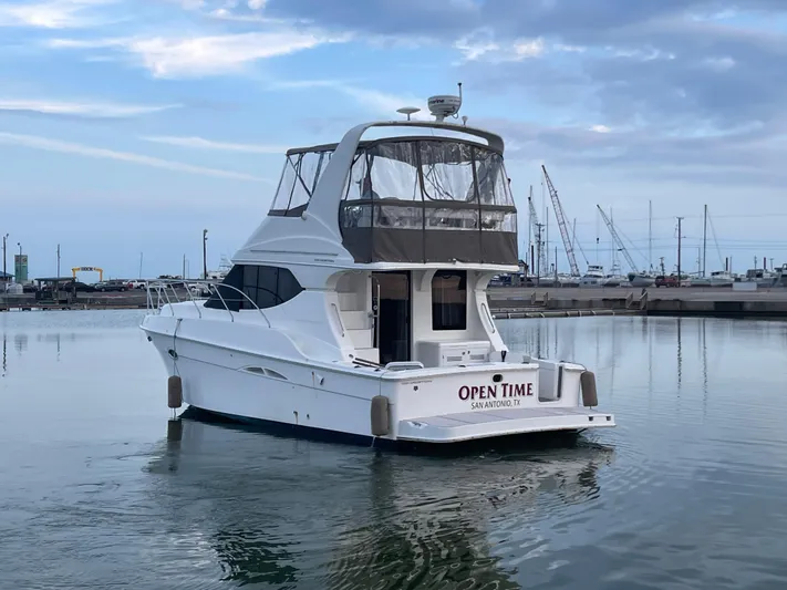 Open Time Yacht Photos Pics 2006 Silverton 34 Convertible yacht on calm water, overcast sky.