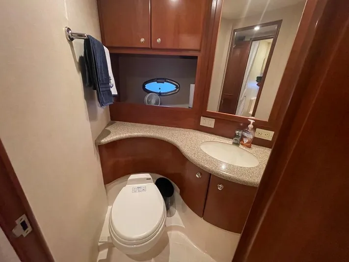 Open Time Yacht Photos Pics 2006 Silverton 34 Convertible yacht bathroom with wood cabinetry and modern fixtures.