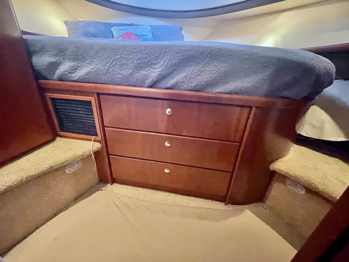 Open Time Yacht Photos Pics Interior of 2006 Silverton 34 Convertible with wooden drawers and carpeted steps.