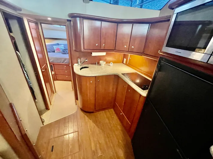 Open Time Yacht Photos Pics Interior of 2006 Silverton 34 Convertible yacht with wood cabinetry and modern kitchen amenities.
