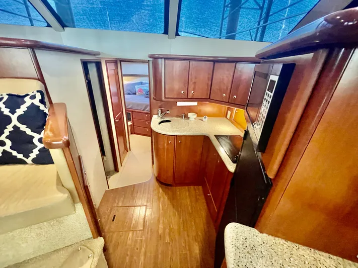 Open Time Yacht Photos Pics 2006 Silverton 34 Convertible yacht interior with wood cabinetry and modern kitchen amenities.