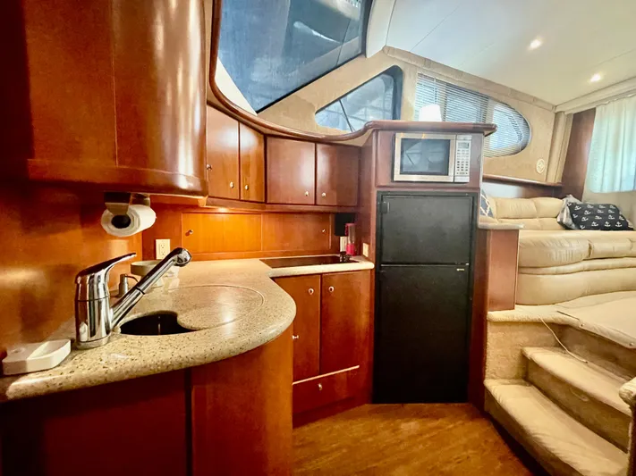 Open Time Yacht Photos Pics Interior of 2006 Silverton 34 Convertible yacht with kitchen and seating area.