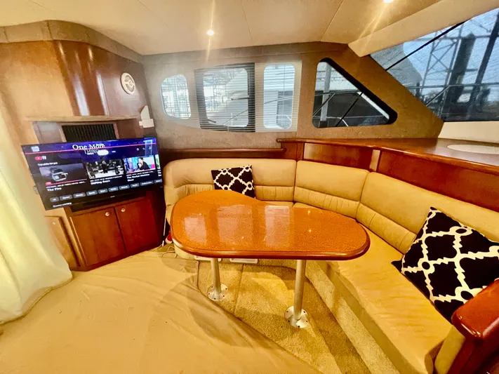 Open Time Yacht Photos Pics Interior of 2006 Silverton 34 Convertible yacht with cozy seating and TV.