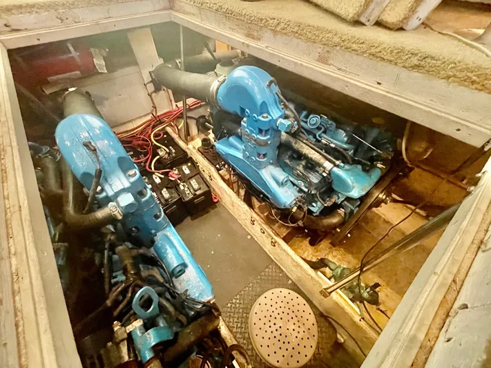 Open Time Yacht Photos Pics Engine compartment of a 2006 Silverton 34 Convertible boat, showcasing dual blue engines.