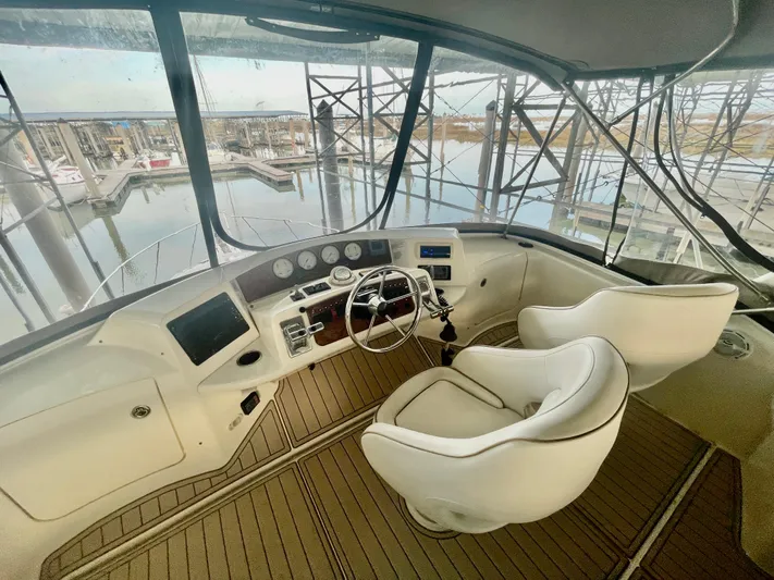 Open Time Yacht Photos Pics 2006 Silverton 34 Convertible yacht helm with dual seats and marina view.