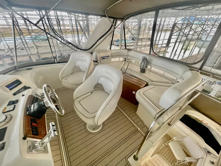 Open Time Yacht Photos Pics 2006 Silverton 34 Convertible yacht interior with helm, seating, and panoramic windows.