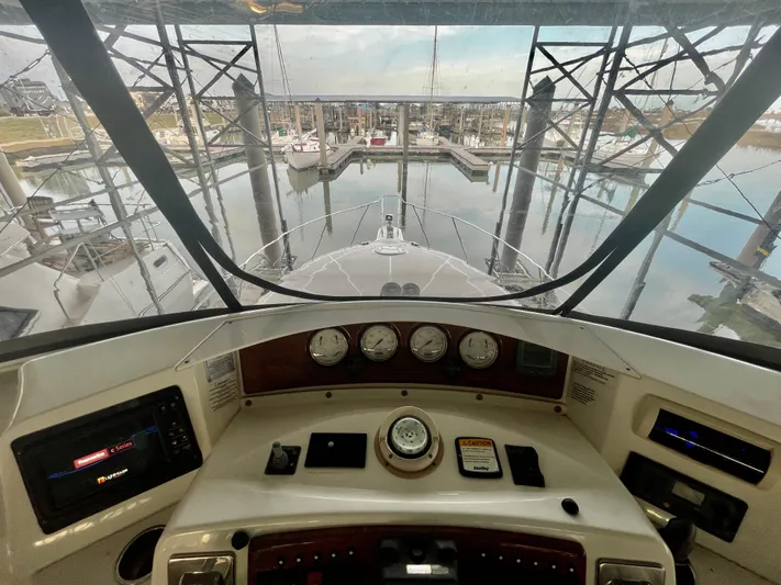 Open Time Yacht Photos Pics 2006 Silverton 34 Convertible yacht helm with marina view.